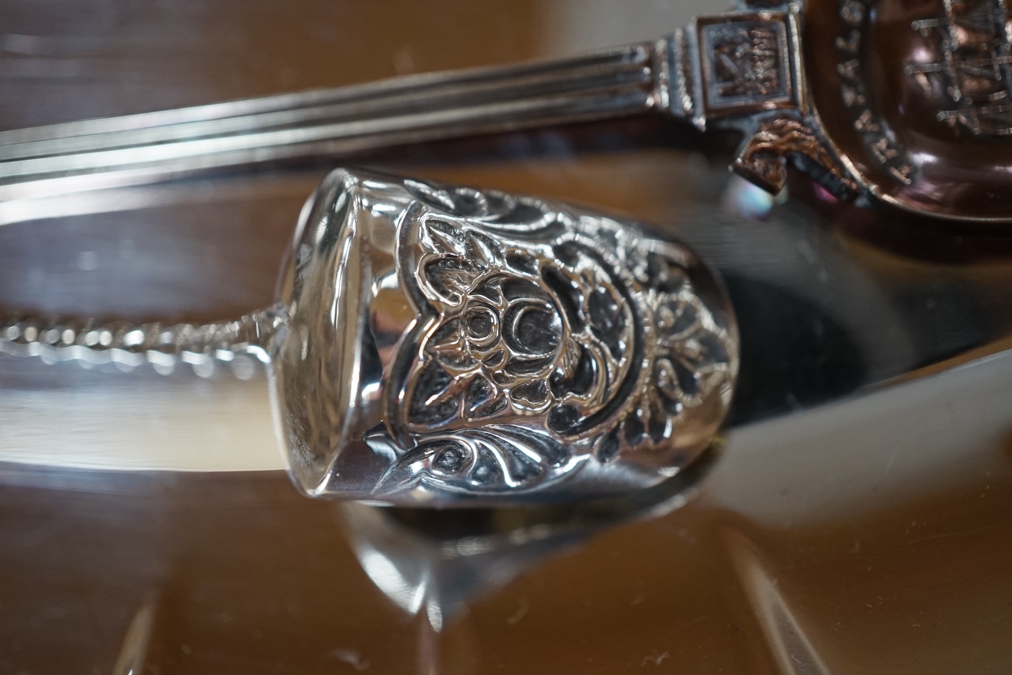 A George III silver toddy ladle with baleen handle, George Knight, London, 1818, a nephrite handled silver butter knife and sugar shovel and a small group of plated items, toddy ladle 35cm long. Condition - fair to good